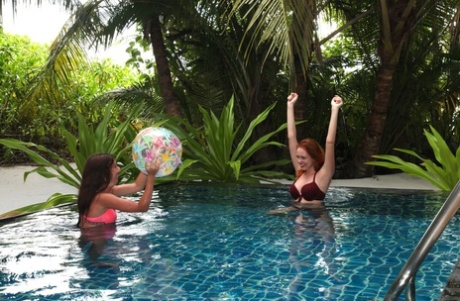 Sultry teens Candy P & Katty West strip and fuck each other in the pool (20 photos)