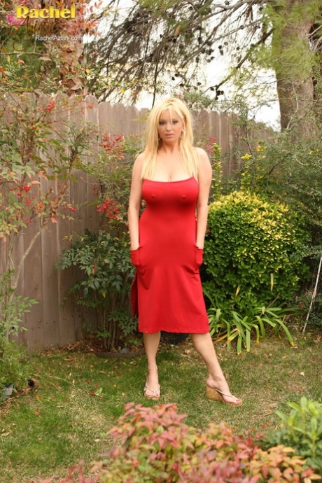 Sexy blonde woman Rachel Aziani frees her big boobs from a borrowed red dress (16 photos)