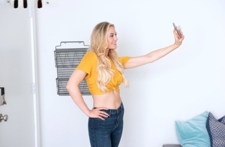 Blond amateur Addie Andrews takes fully clothed selfies before stripping naked (16 photos)