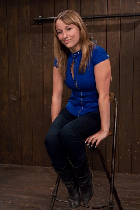 Cute American Jessie Cox gets bound to a metal construction and toyed (20 photos)